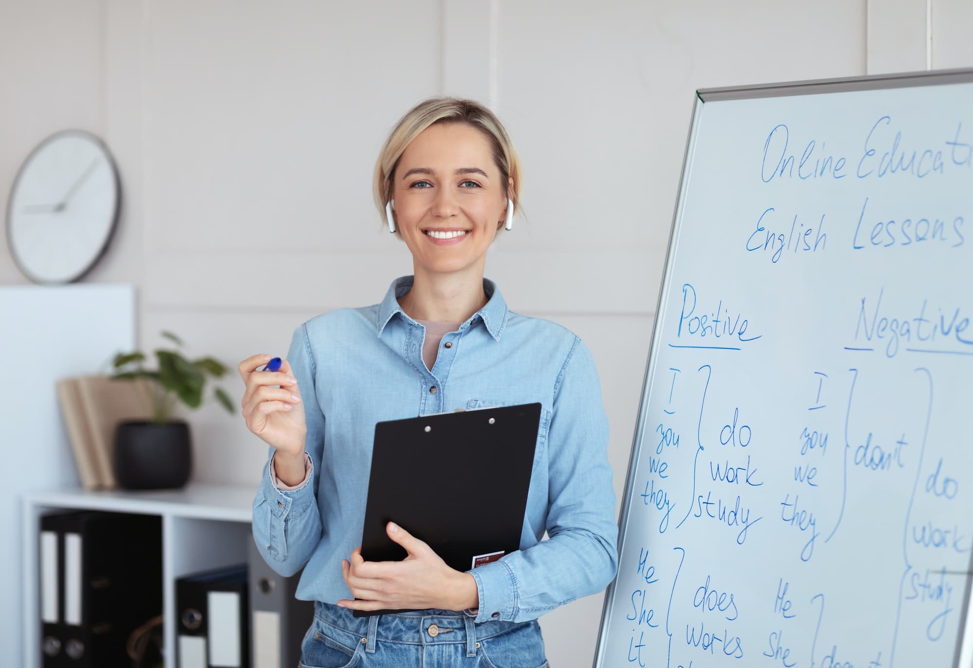 English tutor smiling at the camera while giving an online lesson from home